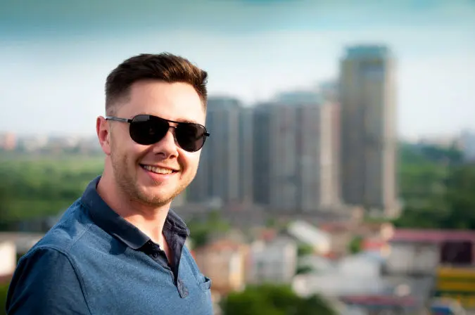 a-man-smiling-wearing-sunglasses