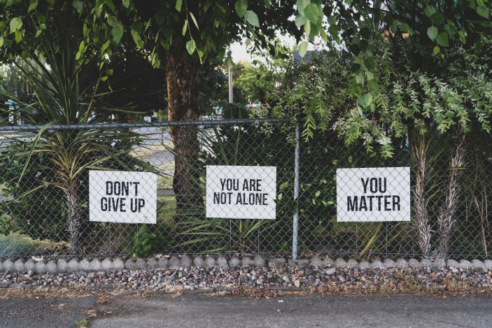 Three-signs-on-a-fence