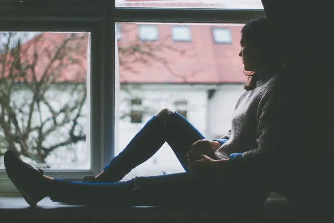 A-woman-looking-out-of-a-window
