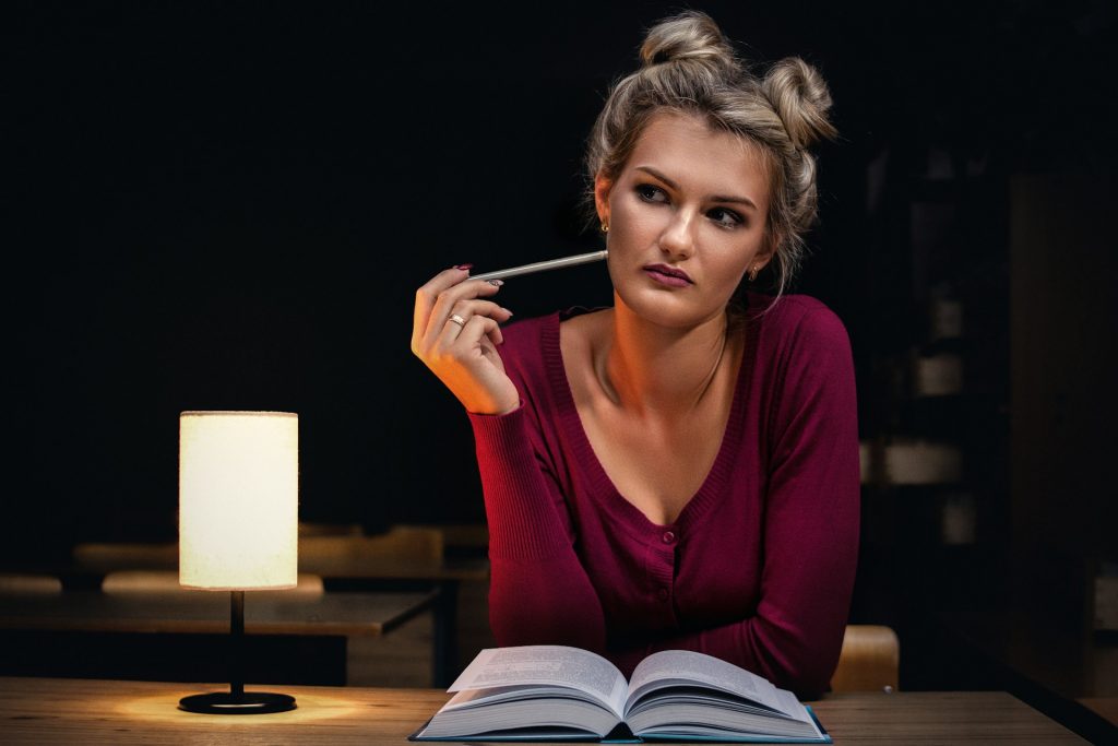 a-young-female-student-in-a-red-top-is-thinking